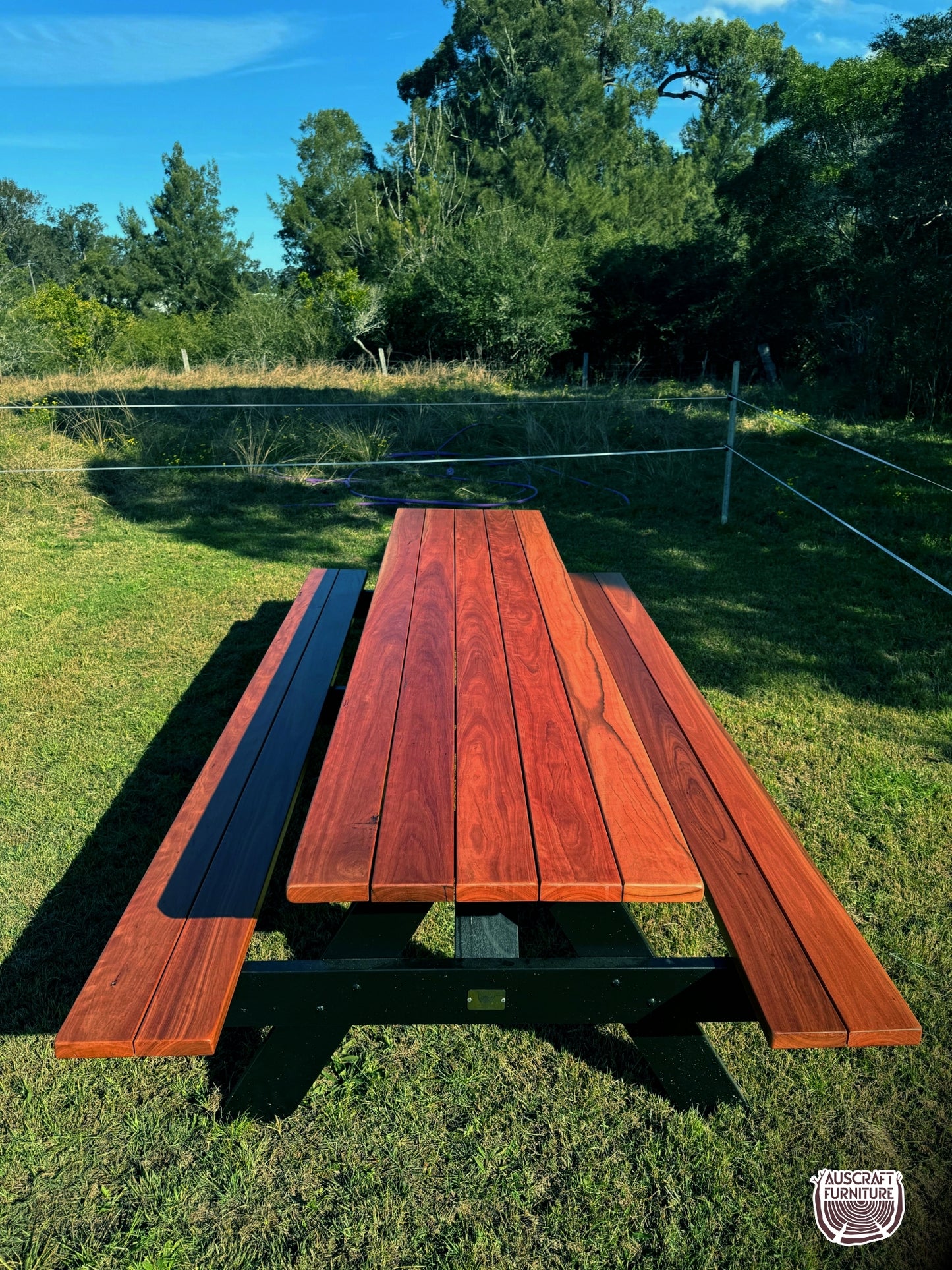 Outdoor hardwood picnic table featuring strong black legs, ideal for Australian gardens, patios, cafés and high-traffic commercial areas