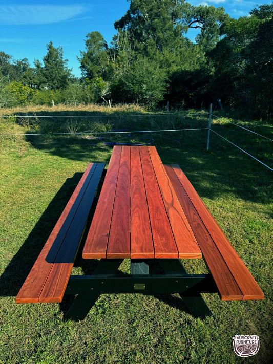 Outdoor hardwood picnic table featuring strong black legs, ideal for Australian gardens, patios, cafés and high-traffic commercial areas