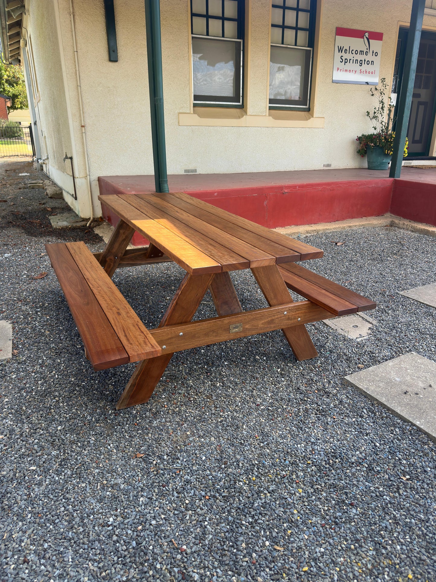 Auscraft outdoor hardwood picnic table with a natural walnut varnished finish, ideal for Australian patios, parks, hospitality venues and home gardens