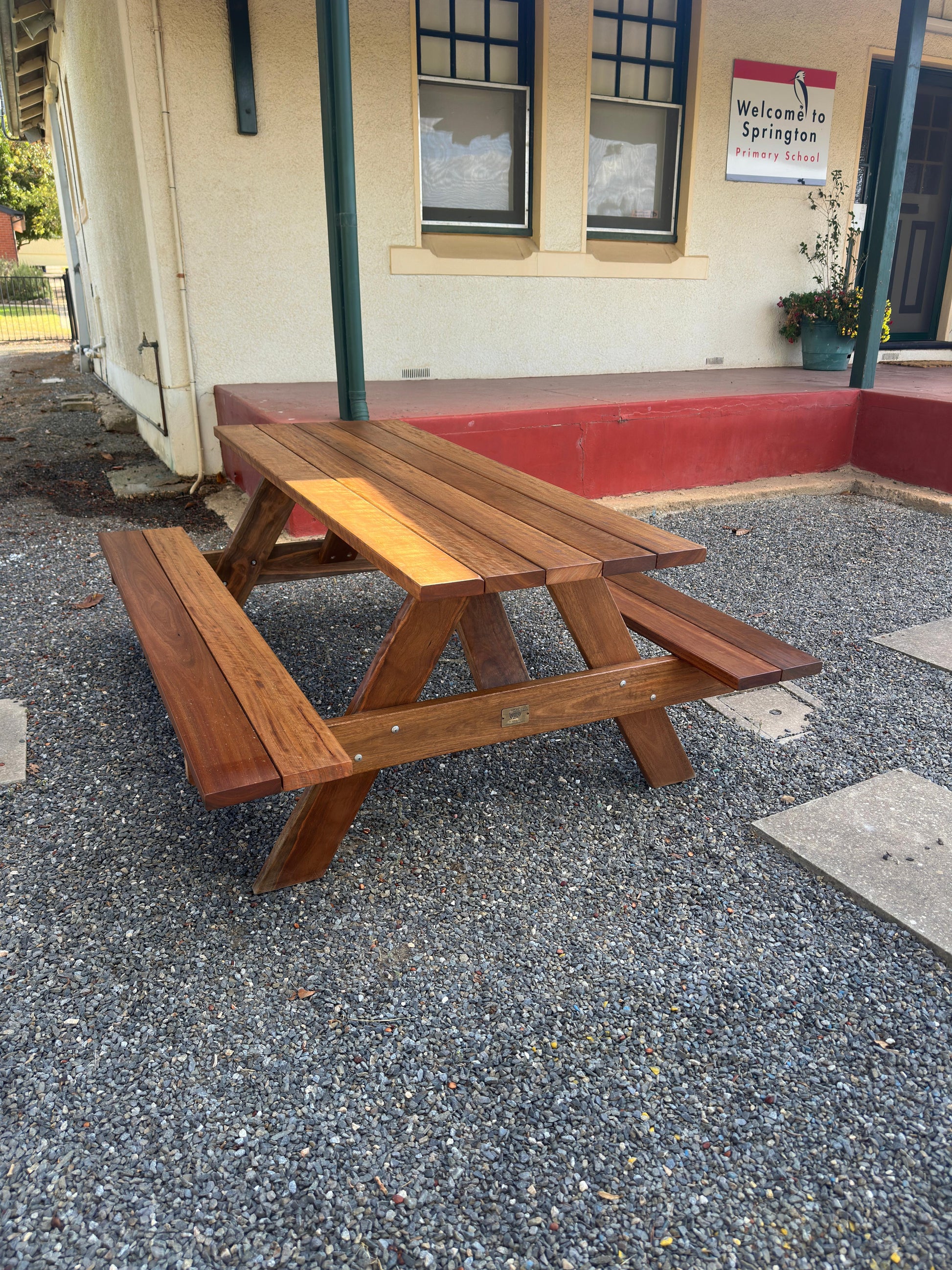 Auscraft outdoor hardwood picnic table with a natural walnut varnished finish, ideal for Australian patios, parks, hospitality venues and home gardens