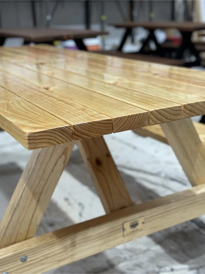 Varnished natural wood picnic table for café patios, combining warmth and durability for outdoor use in Australia