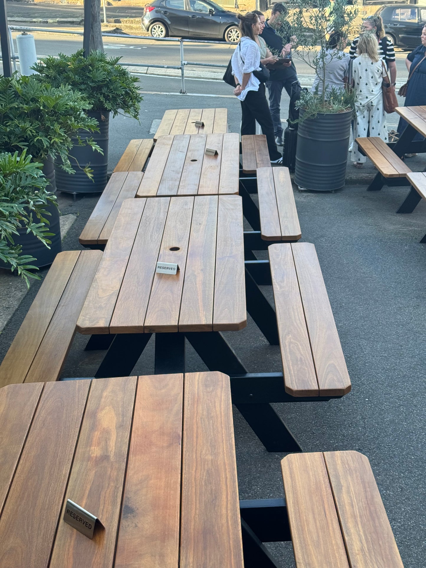 Durable commercial picnic table for Melbourne event cafés and festival venues, suitable for large outdoor crowds.