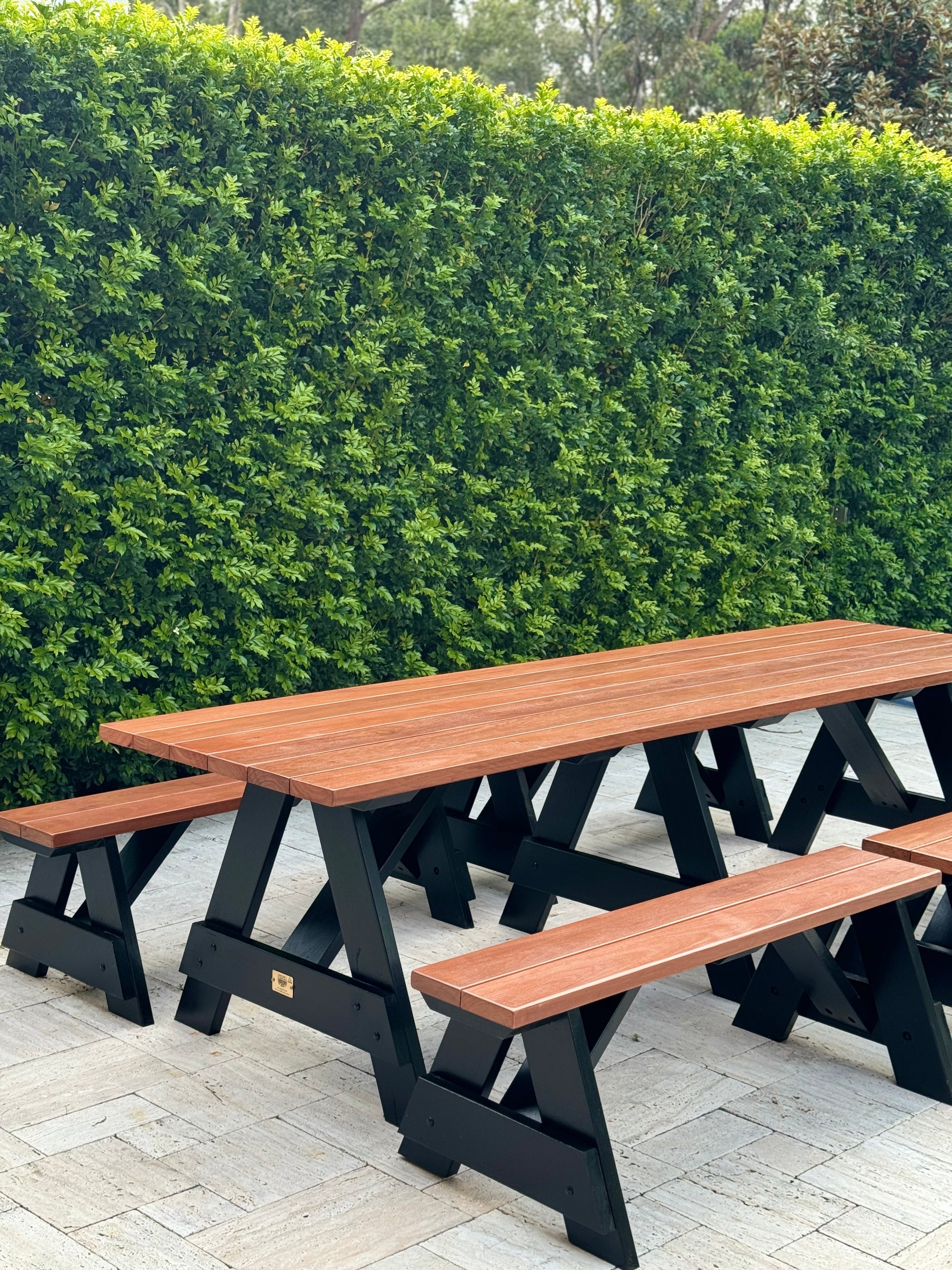 Hardwood picnic table with black legs for shared courtyards in residential and mixed-use property developments in Australia