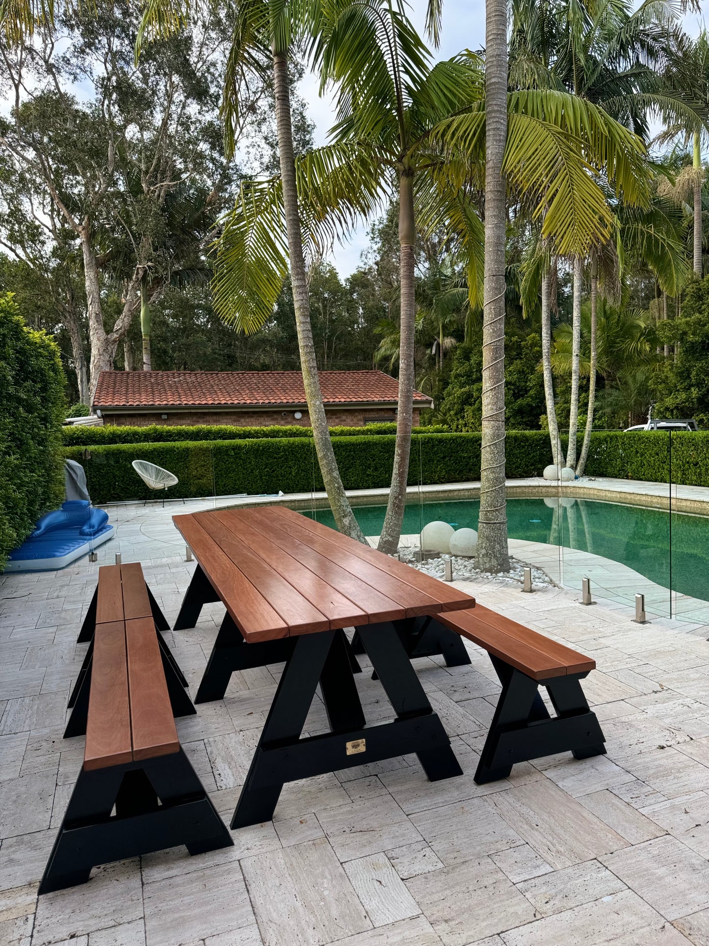 Varnished hardwood picnic table with black frame for shared courtyards in residential and mixed-use property developments in Australia