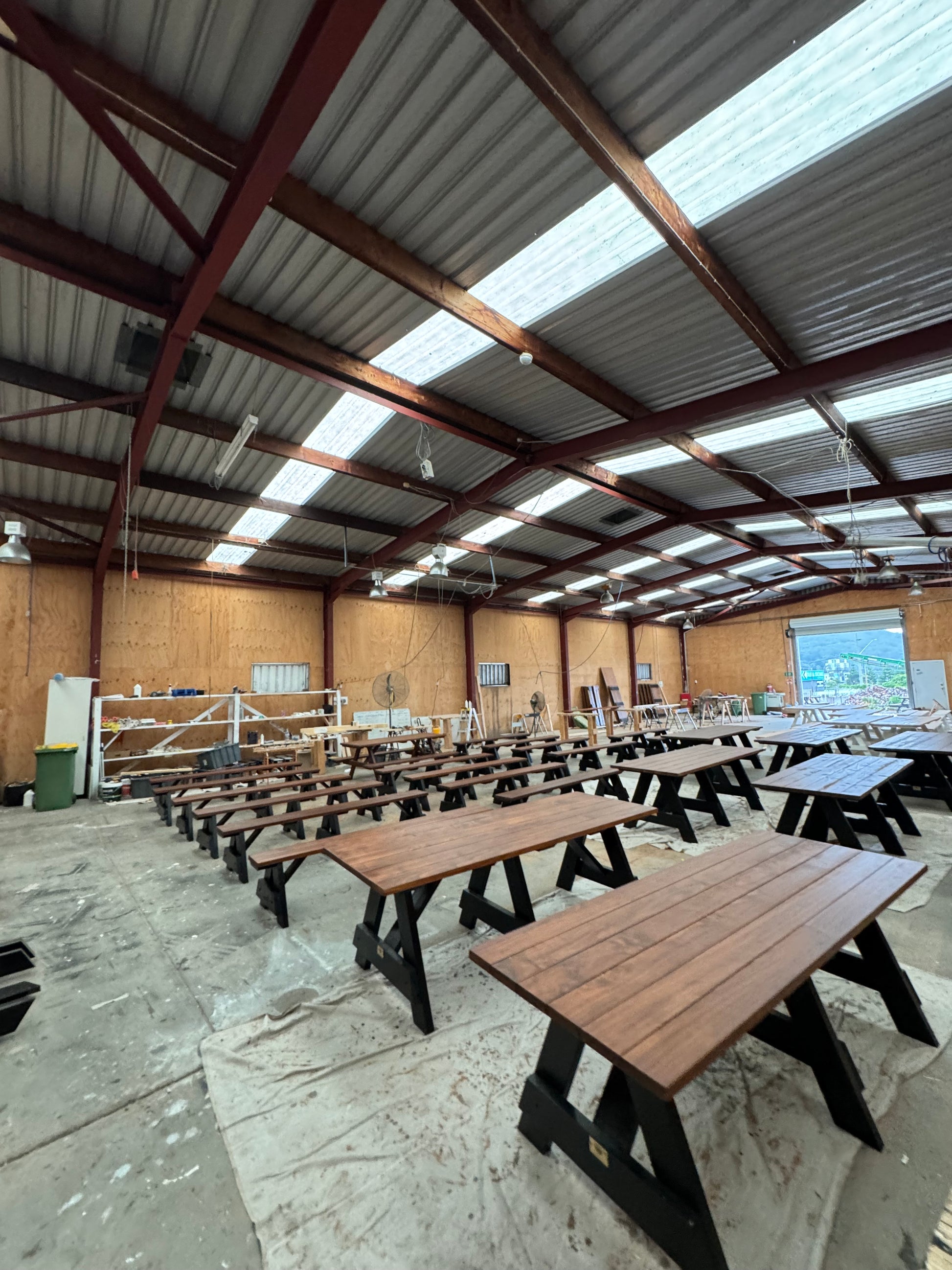 Walnut stain heavy-duty outdoor table with black legs suitable for restaurants, cafes, and commercial alfresco areas in Australia