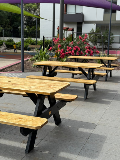 Commercial grade picnic table with custom stain timber top and black legs, built for high-traffic restaurant outdoor dining areas in Australia