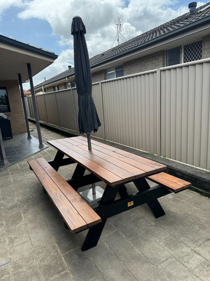 Commercial grade walnut picnic table with black legs and umbrella hole for shaded restaurant dining in Australia
