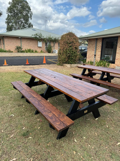 Walnut top heavy duty picnic table with black legs designed for high-traffic outdoor areas, offering strong construction, weather resistance, and long-lasting performance in Australia