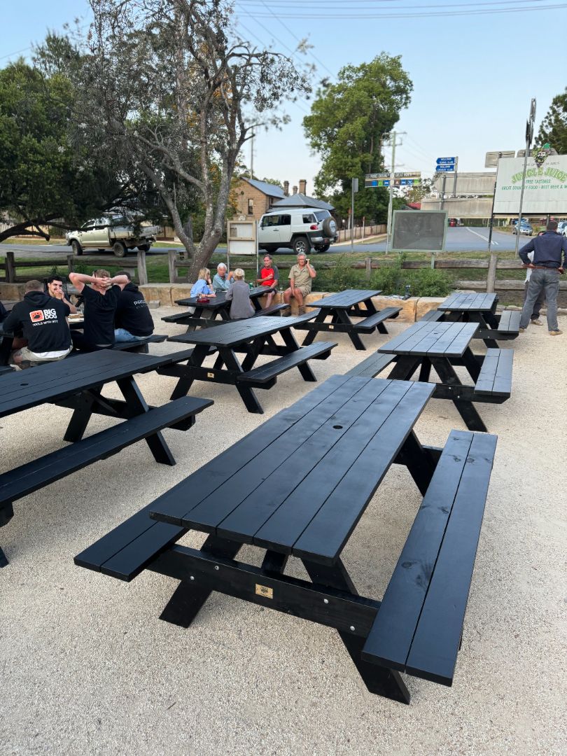Black heavy duty picnic table with umbrella hole perfect for parks and public spaces requiring strong, weather-resistant shaded seating in Australia