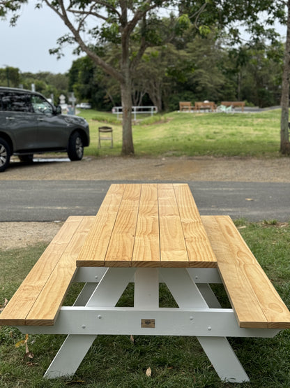 Durable raw wood picnic table with white frame suited for outdoor workshop spaces and hands-on training areas in Australia
