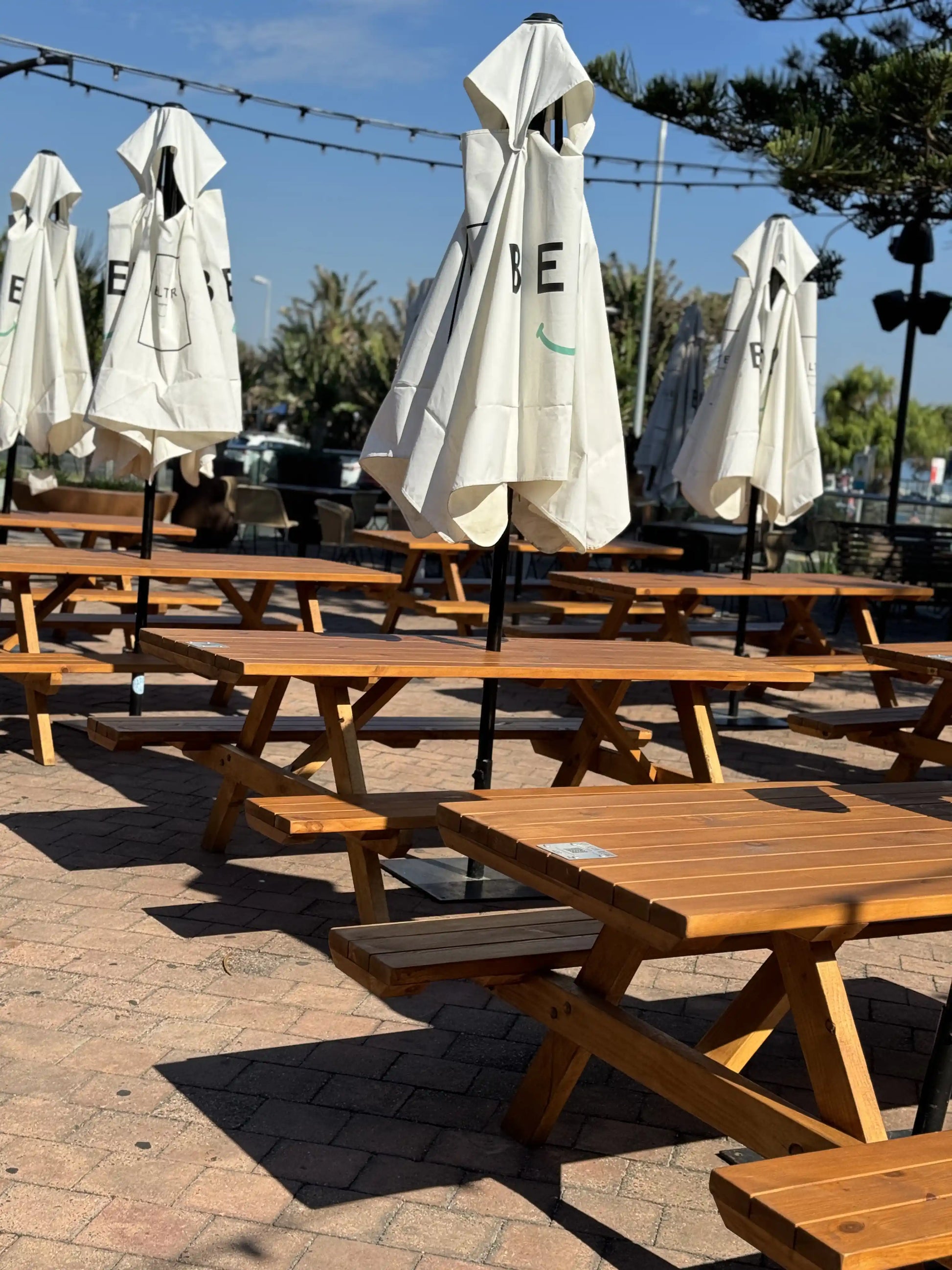 Light walnut commercial picnic table by Auscraft, ideal for outdoor seating in Australian cafés, restaurants and bar venues