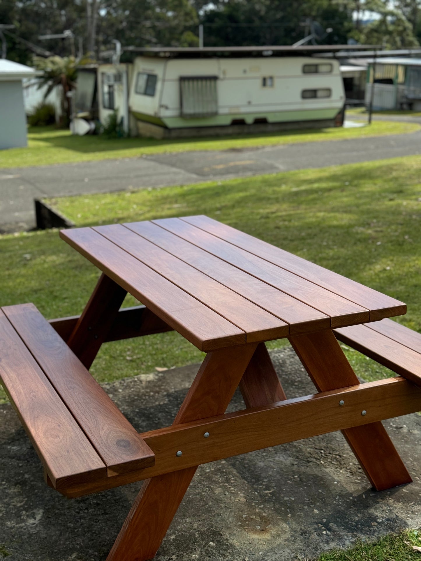 Auscraft outdoor hardwood picnic table with a full walnut varnished finish, ideal for Australian patios, parks, hospitality venues and home gardens