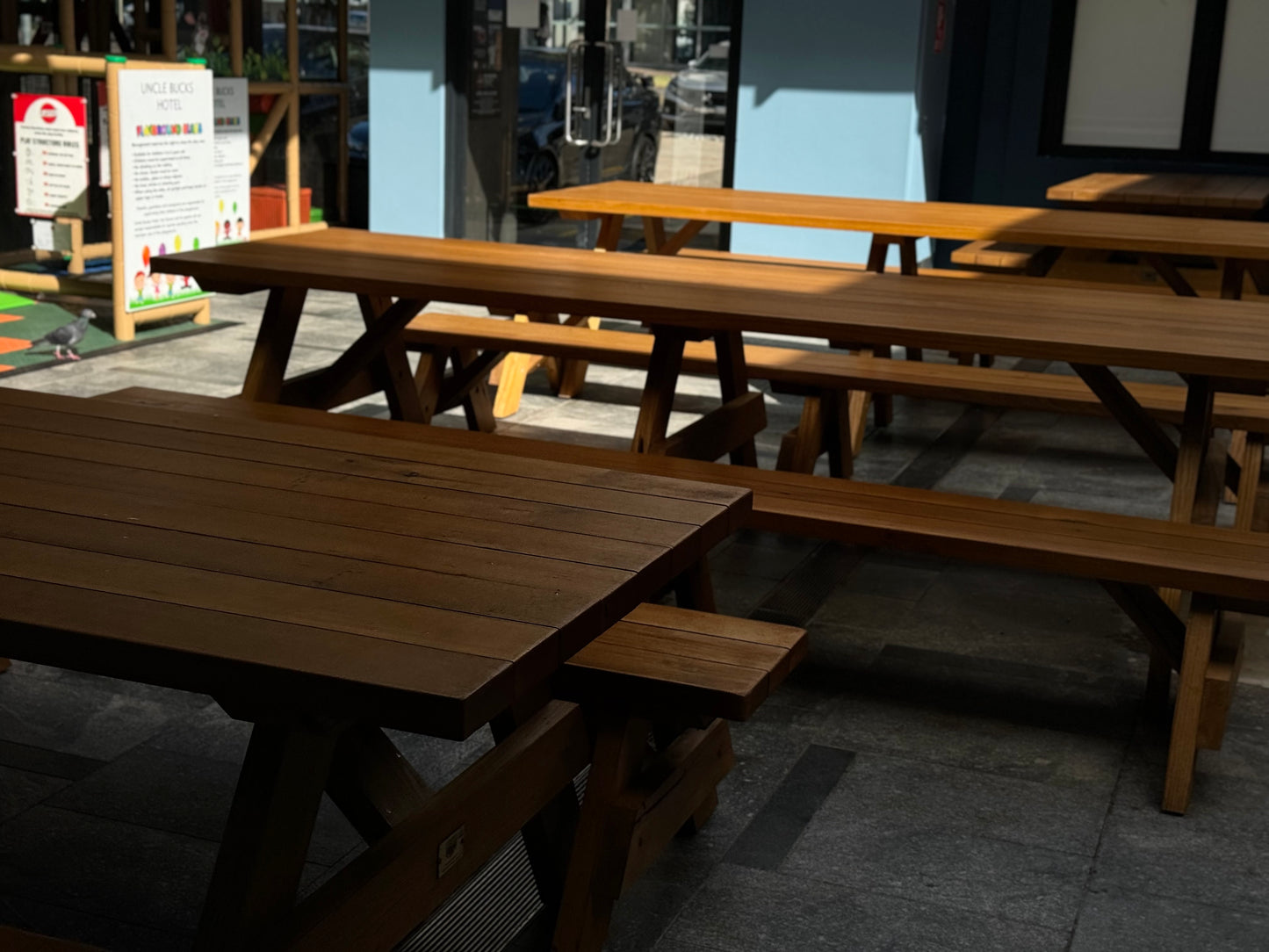 Raw walnut hardwood picnic table designed for covered outdoor areas and sheltered spaces in Australia