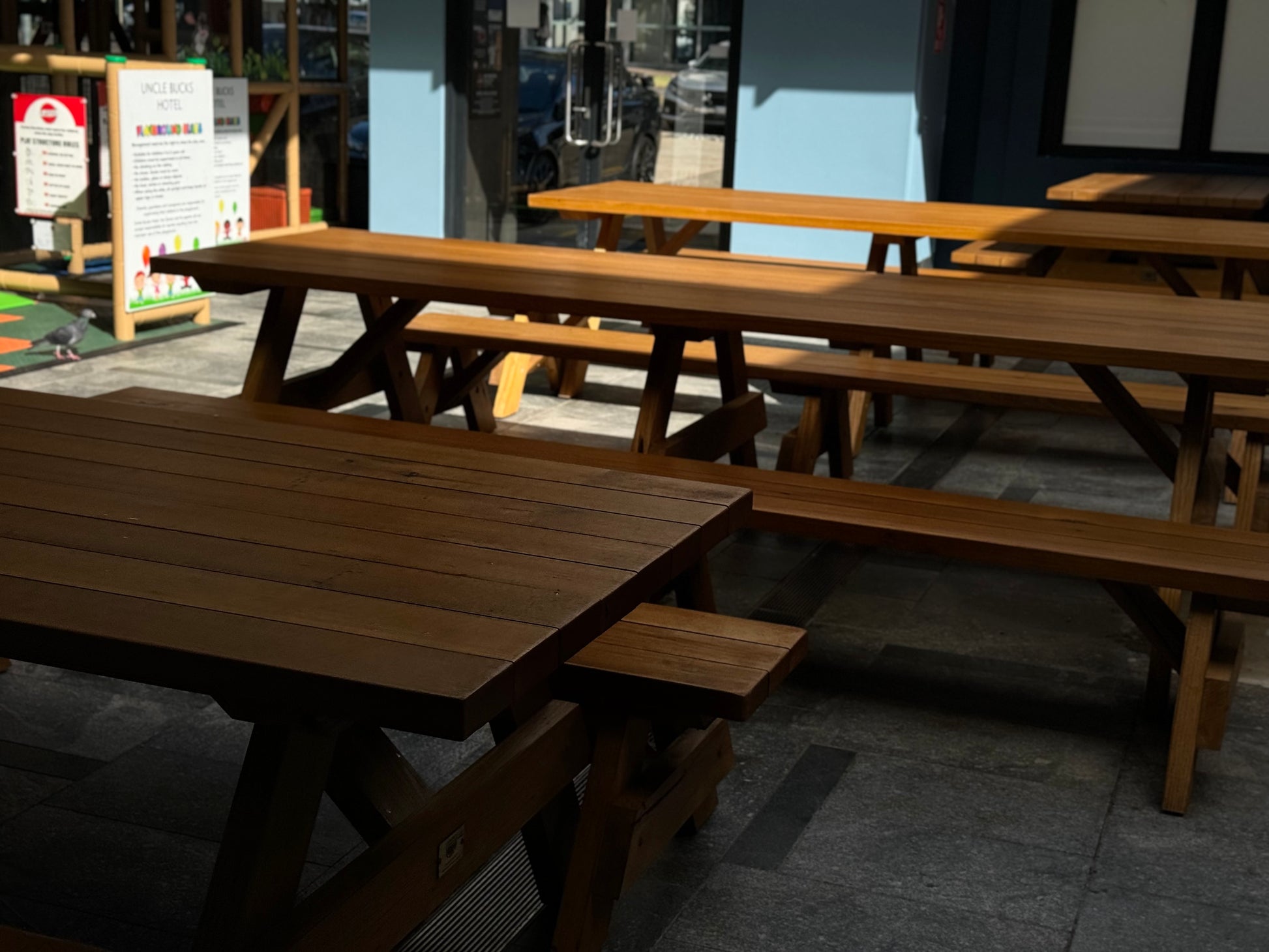 Raw walnut hardwood picnic table designed for covered outdoor areas and sheltered spaces in Australia