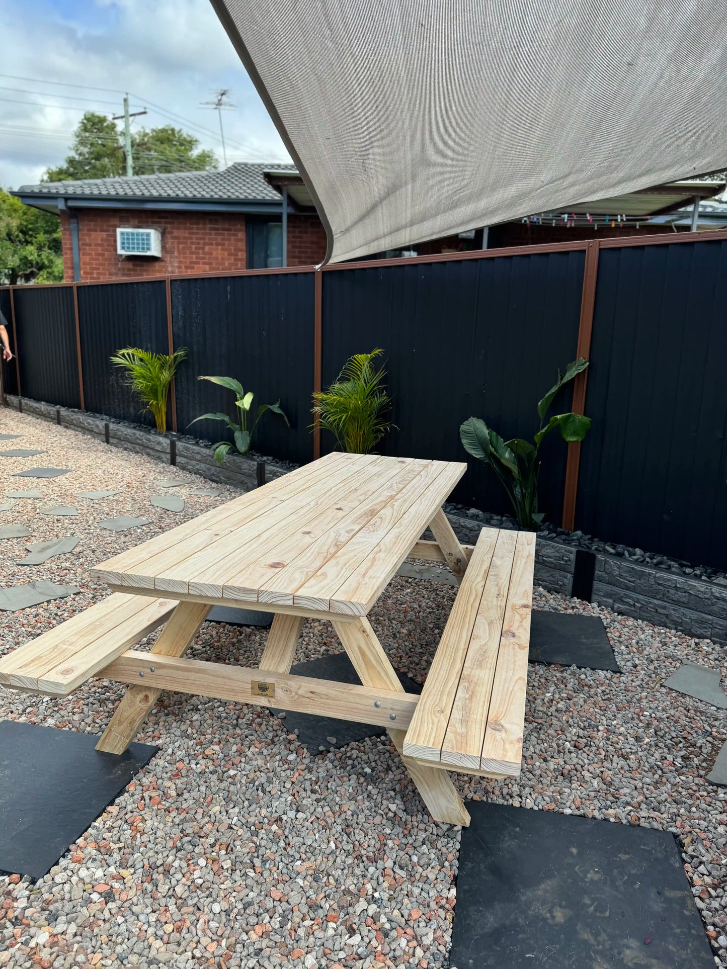 Natural timber-look picnic table by Auscraft, ideal for stylish and landscaped garden areas across Australian outdoor living environments