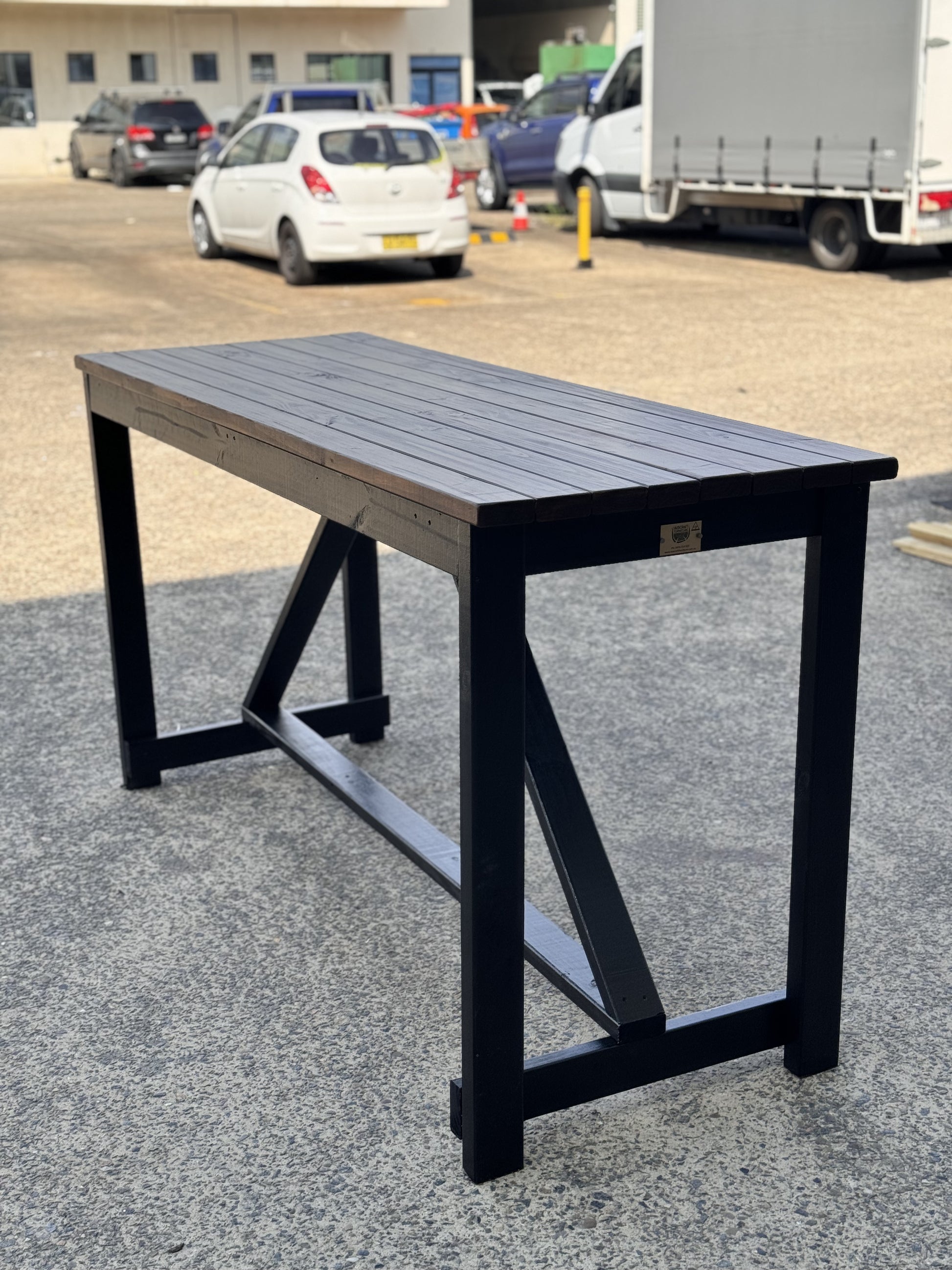 Handcrafted solid wood high bar table with custom stain and black legs for residential use