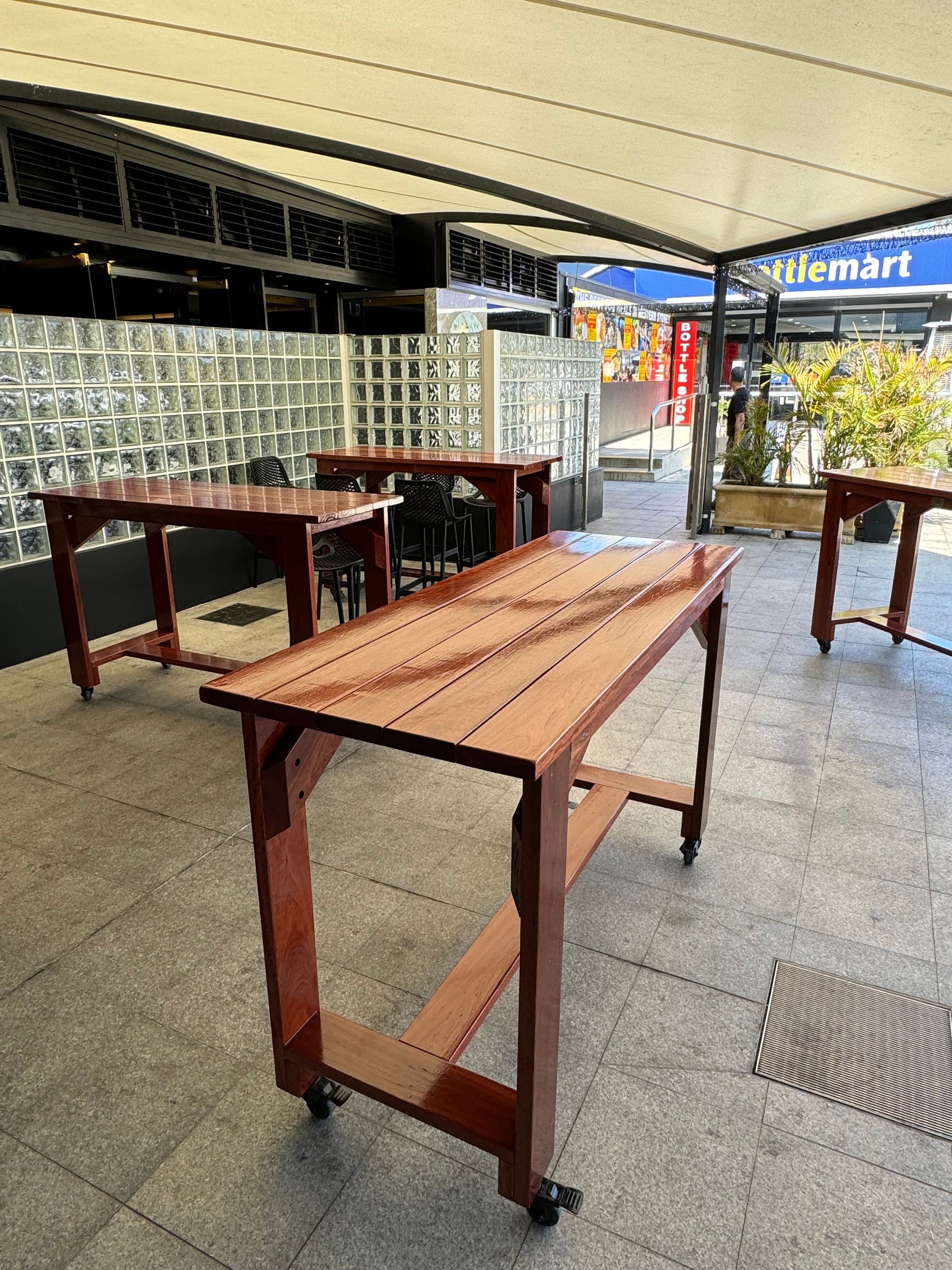 Durable walnut stain high bar table for beachside cafés and outdoor seating areas
