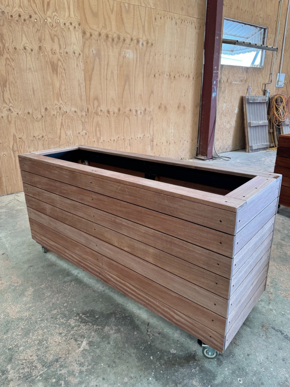 Durable traditional planter box made from kiln-dried Jambu hardwood, ideal for shopping mall entrances and atriums to enhance aesthetics.