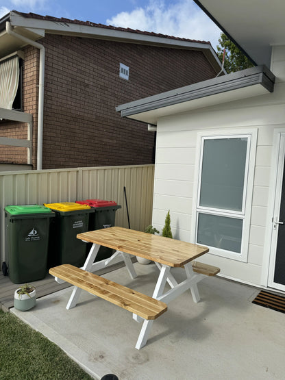 varnished pine picnic table with white legs outdoor garden Australia