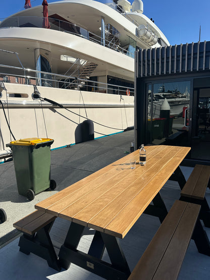 Walnut hardwood picnic table with black legs designed for shared courtyards in residential and mixed-use developments in Australia