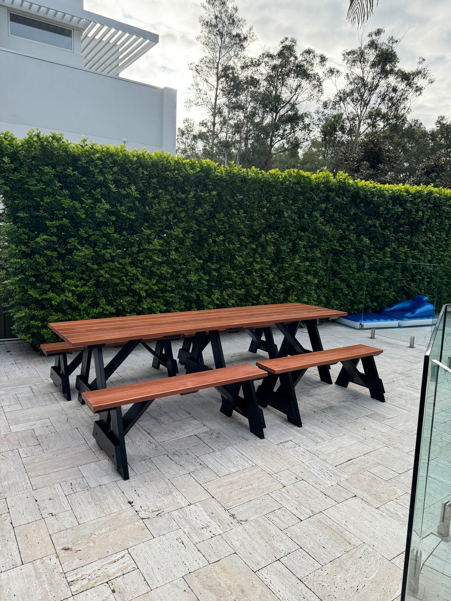 Walnut hardwood picnic table with black legs, highlighting natural timber grain and durable outdoor construction for Australian conditions