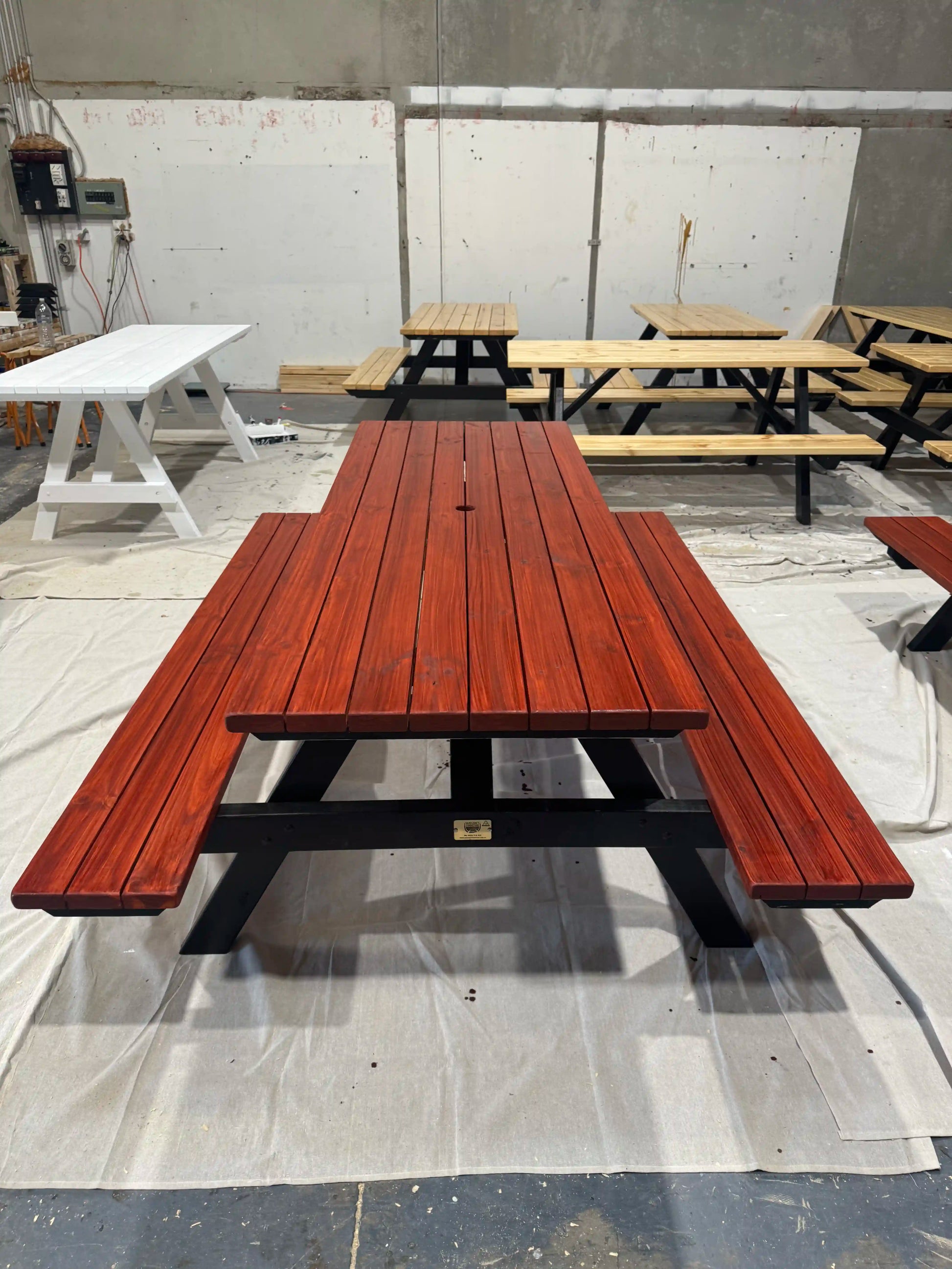 Walnut picnic table with black legs suited for event venues and large outdoor social spaces in Australia