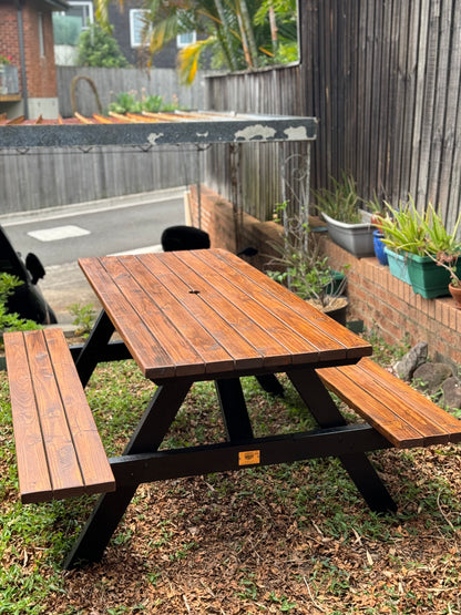 Custom walnut picnic table featuring black legs by Auscraft, ideal for stylish garden and outdoor spaces across Australia